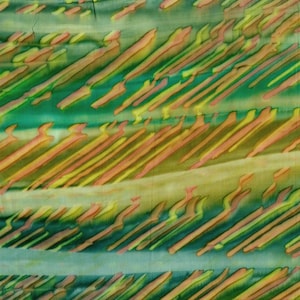 May include: Abstract textile with a watercolor effect. The fabric features diagonal brushstrokes in shades of green, yellow, and orange. The design has a layered appearance, with varying tones and textures creating depth and visual interest.