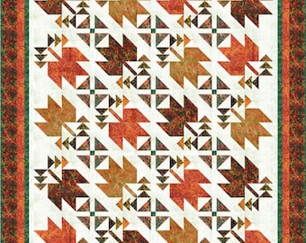 May include: A fall-themed quilt with a repeating pattern of stylized maple leaves in shades of orange, brown, and green. The leaves are set against a cream background and framed by a patterned border in complementary colors. The quilt is a patchwork design.