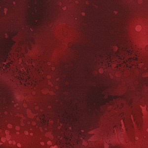 May include: Abstract red background with a mottled, speckled, and splatter effect. The background is a deep red with lighter red and dark red speckles and splatters.