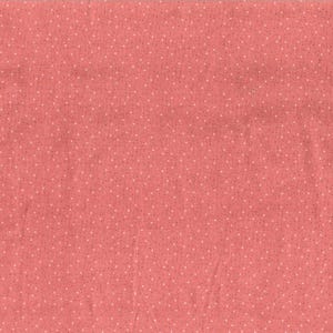 May include: A solid coral pink fabric with a white polka dot pattern.