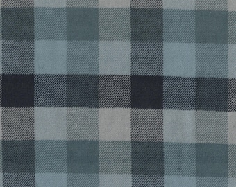 May include: Close-up of a fabric with a plaid pattern. The pattern features a grid of squares in shades of blue, gray, and black. The fabric has a textured appearance, with visible woven threads. The overall aesthetic is casual and suitable for apparel or home decor.