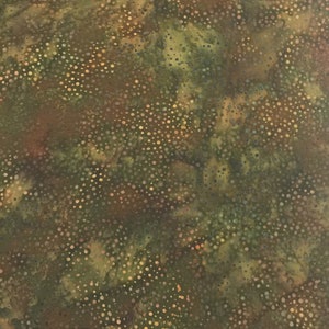 May include: A fabric with a mottled pattern in shades of green, brown, and gold. The design features small, scattered dots across the surface, creating a textured appearance. The overall effect is reminiscent of a natural, organic landscape.