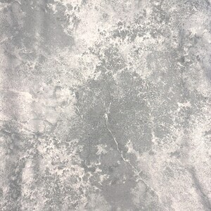May include: A close-up view of a textured surface with a marbled appearance. The color palette consists of shades of gray and white, creating a mottled effect. The surface has a rough, uneven texture with visible variations.