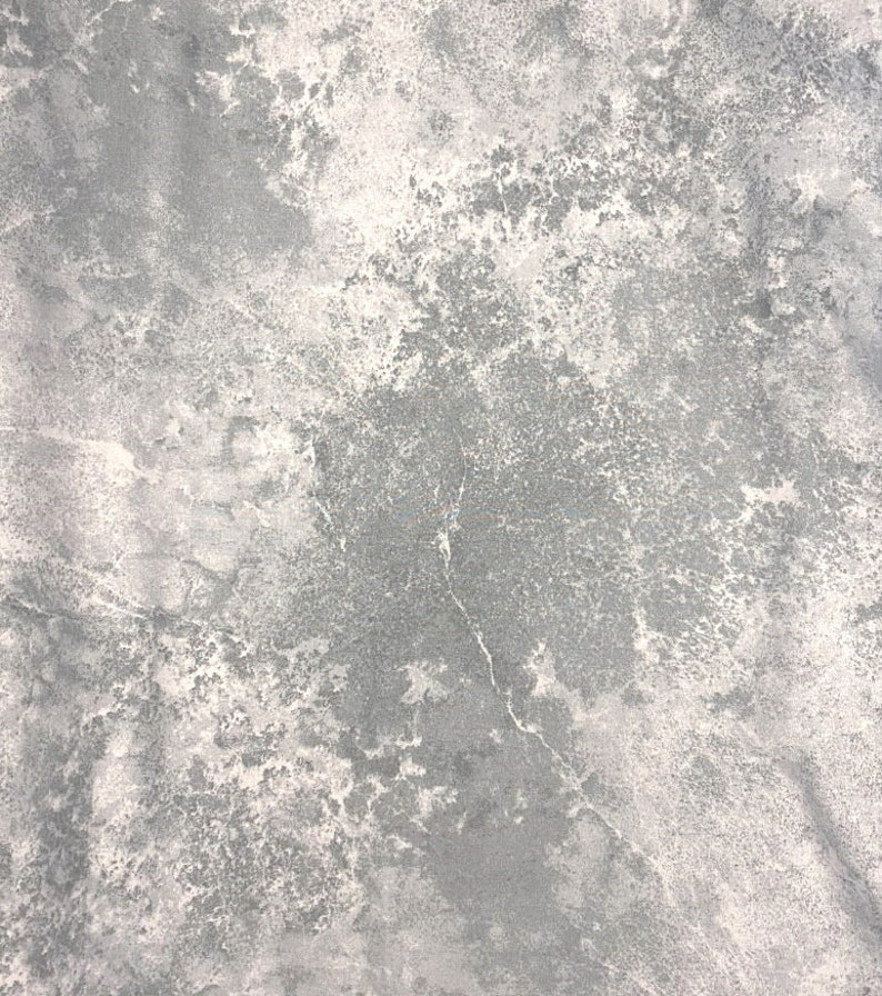 May include: A close-up view of a textured surface with a marbled appearance. The color palette consists of shades of gray and white, creating a mottled effect. The surface has a rough, uneven texture with visible variations.