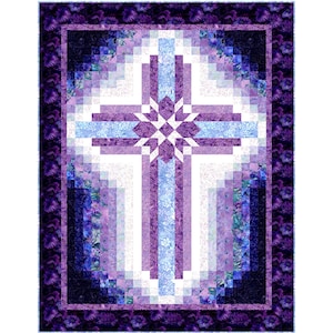May include: A quilted wall hanging featuring a cross design. The cross is composed of light and dark purple, and light blue rectangular blocks. The background is white. The border is dark purple with a floral pattern.