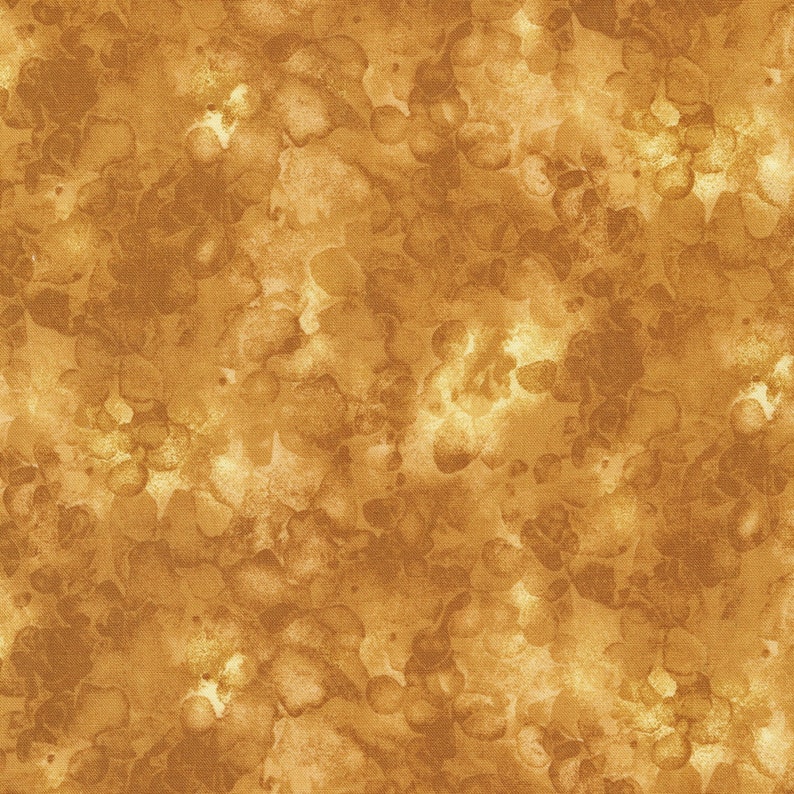 May include: A seamless fabric pattern featuring a watercolor-like design in shades of gold and brown. The pattern has a mottled appearance with irregular, organic shapes, creating a textured and artistic look. The fabric appears to be a cotton or linen blend.