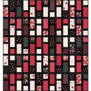 May include: A patchwork quilt featuring a repeating pattern of red, black, and cream-coloured rectangles and squares. Some rectangles have floral patterns. The quilt's design is symmetrical, with a grid-like arrangement of the blocks.