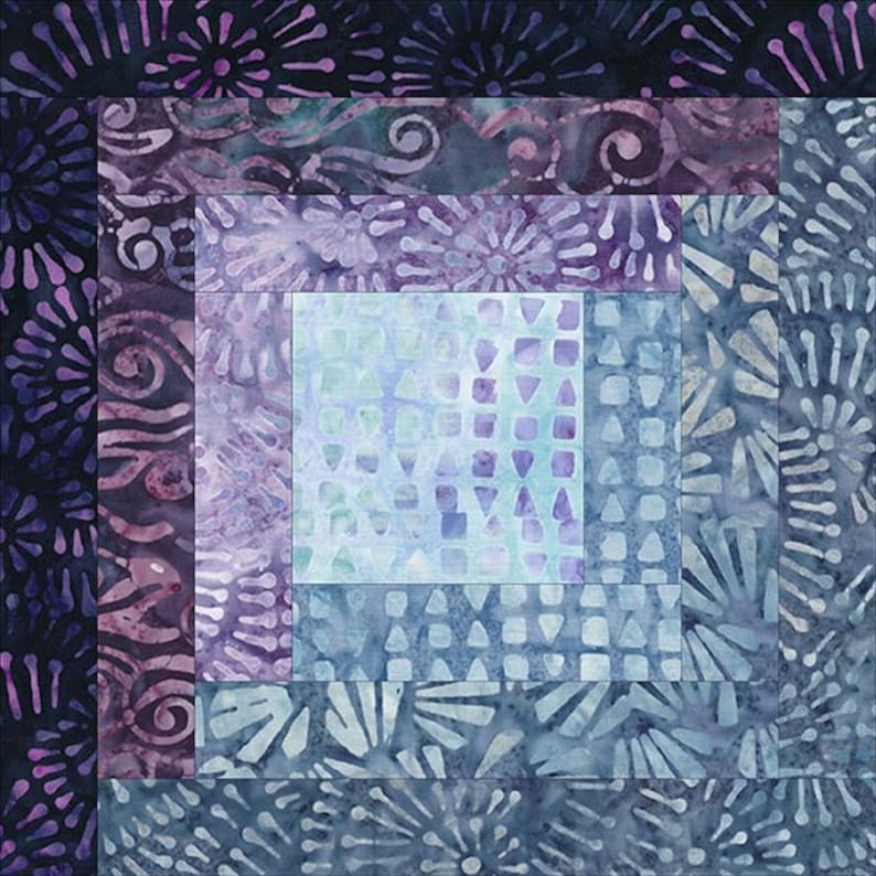 May include: A quilt block with a log cabin pattern in shades of blue and purple. The center of the block is a light blue square with a geometric pattern. The outer layers of the block feature a variety of floral and swirl patterns.