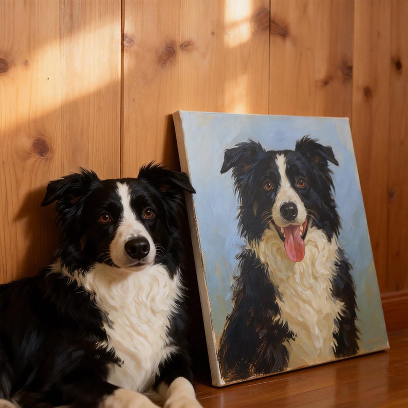 May include: A black and white Border Collie dog lying next to a canvas painting of a similar dog. The painting has a light blue background. The dog in the image has brown eyes and a white chest.