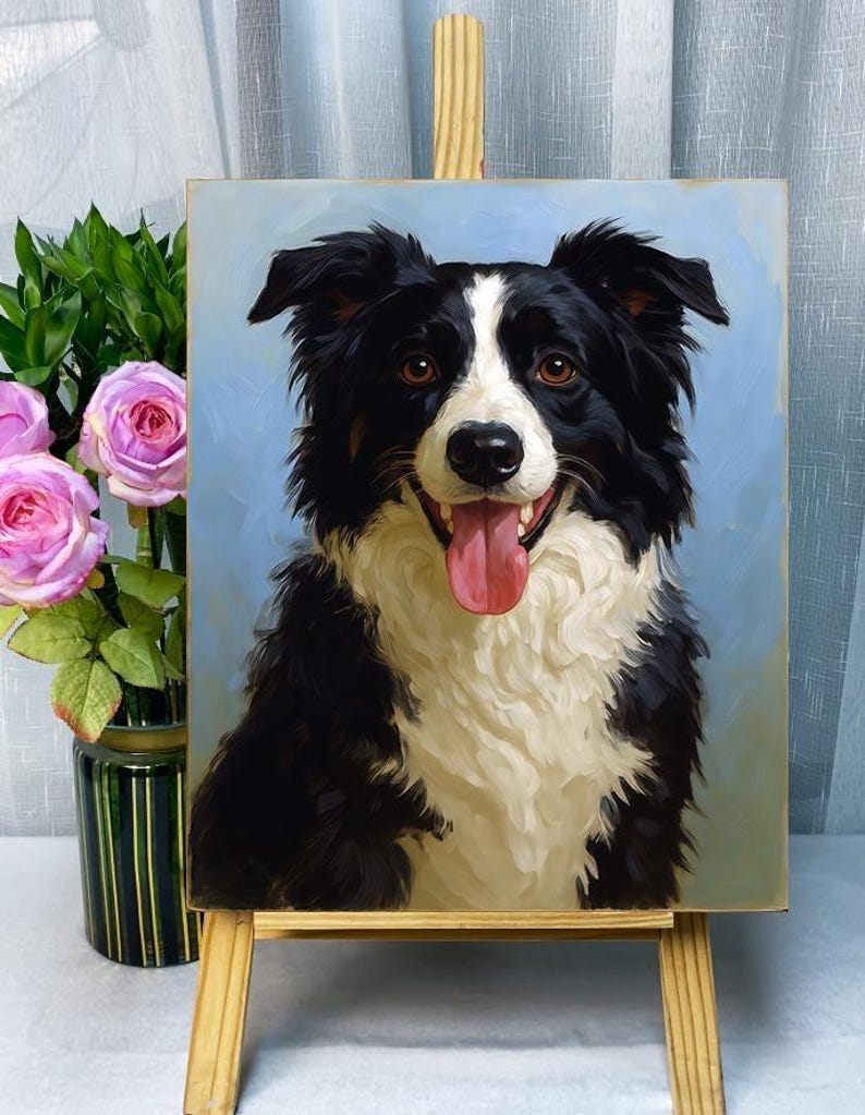 May include: A painting of a Border Collie dog with black and white fur, brown eyes, and a pink tongue. The dog is smiling, and the background is a light blue. The painting is displayed on a small wooden easel.