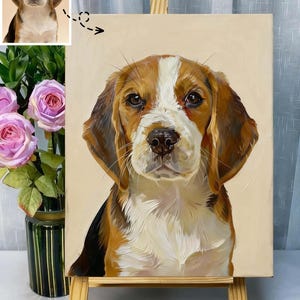 May include: A detailed oil painting of a Beagle dog, showcasing its brown, white, and black fur. The artwork is displayed on a small wooden easel, with a reference image in the upper left corner. The background is a soft beige.