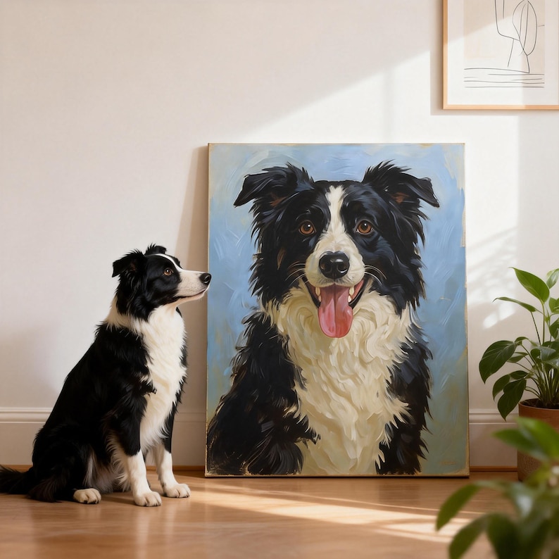 May include: A black and white Border Collie dog sits on a wooden floor next to a framed painting of a similar dog. The painting has a light blue background and the dog is smiling with its tongue out. A houseplant is in the background.