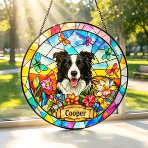May include: A circular stained glass suncatcher featuring a black and white Border Collie portrait surrounded by colorful flowers and dragonflies. A central banner at the bottom displays the name Cooper in black text against a gold background.