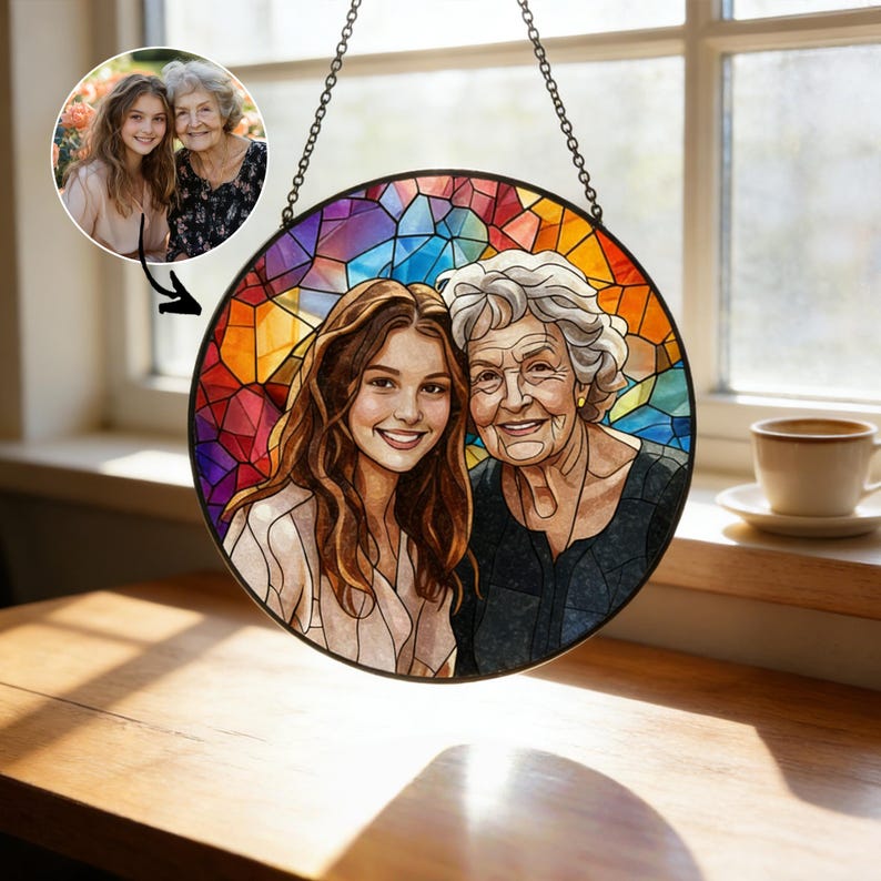 May include: A round stained glass window with a photo of two women, one young and one older, hanging from a chain. The background is a mosaic of colorful geometric shapes. A smaller photo of the women is in the upper left corner.