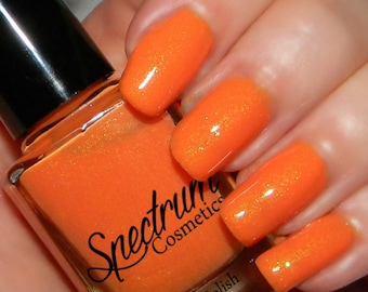 May include: Orange nail polish with a shimmer finish. The bottle is labeled "Spectrum Cosmetics" and "Nail Polish".