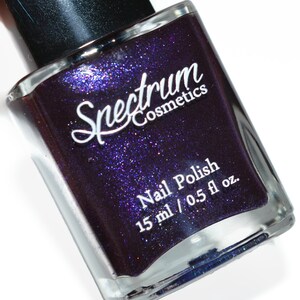 May include: A bottle of Spectrum Cosmetics nail polish in a deep purple colour with silver glitter. The bottle is labelled "Nail Polish" and "15 ml / 0.5 fl oz."