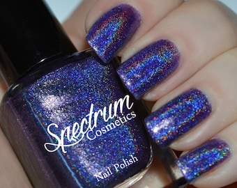 May include: A bottle of Spectrum Cosmetics nail polish in a deep purple color with a holographic finish. The bottle is labeled "Spectrum Cosmetics Nail Polish".