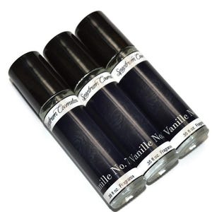 May include: Three perfume bottles with black caps and labels that read "Vanille No. 7" and "Spectrum Cosmetics." Each bottle contains 0.35 fl oz of fragrance. The bottles are dark blue with a subtle pattern.