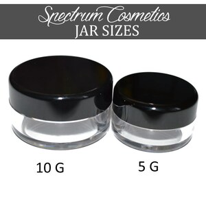 May include: Two clear plastic jars with black lids. The larger jar is labelled "10 G" and the smaller jar is labelled "5 G".