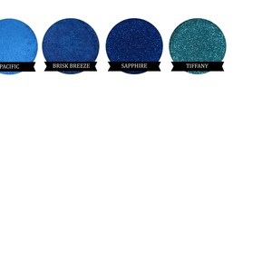 May include: Four round eyeshadow samples in shades of blue and teal. The shades are labelled "Pacific", "Brisk Breeze", "Sapphire", and "Tiffany".