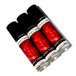 May include: Three roll-on fragrance bottles with black caps and red labels. The labels read "CHERRY EMBER" and "35 fl oz. Fragrance". The bottles are angled on a white background.
