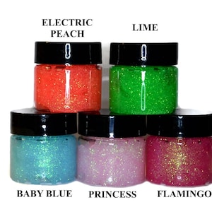 May include: Five small jars of glitter glue in various colors. The colors are Electric Peach, Lime, Baby Blue, Princess, and Flamingo.