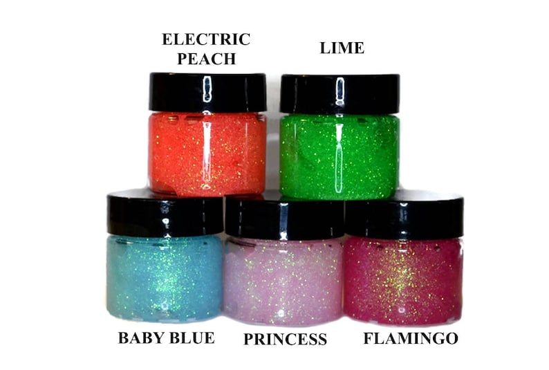 May include: Five small jars of glitter glue in various colors. The colors are Electric Peach, Lime, Baby Blue, Princess, and Flamingo.