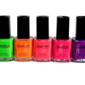 May include: Seven bottles of neon nail polish in yellow, green, orange, pink, red, purple, and blue. Each bottle is labeled "Spectrum Cosmetics" and "Nail Polish 15 ml / 0.5 fl oz."