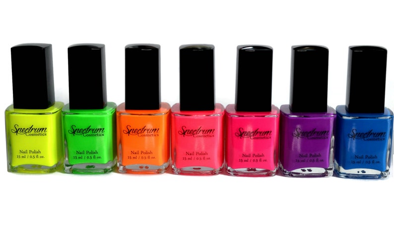 May include: Seven bottles of neon nail polish in yellow, green, orange, pink, red, purple, and blue. Each bottle is labeled "Spectrum Cosmetics" and "Nail Polish 15 ml / 0.5 fl oz."