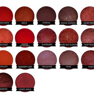 May include: A palette of 14 red and brown eyeshadows with names like "Blood Bath", "Brick", "Queen of Hearts", "Raspberry", "Ruby Red Slipper", "Snap Dragon", "Fatality", "Naughty List", "Trickster", "Wine", "Vixen", "Crimson", and "Candy Apple".