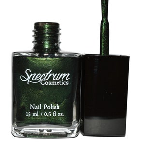 May include: A bottle of Spectrum Cosmetics nail polish in a dark green color with a shimmer finish. The bottle is 0.5 fl oz (15 ml).