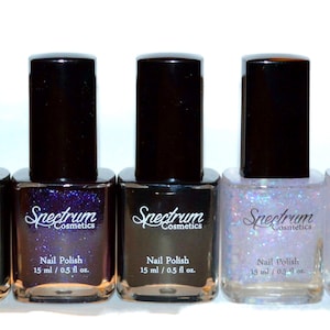 May include: Eight bottles of Spectrum Cosmetics nail polish in various colours, including red, green, purple, black, and silver. Each bottle is labelled "Nail Polish" and contains 15 ml / 0.5 fl oz.