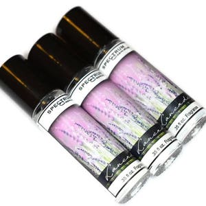 May include: Three 0.35 fl oz bottles of lavender scented fragrance oil. The bottles are black with white labels that say "Spectrum" and "Lavender" with a lavender flower design.