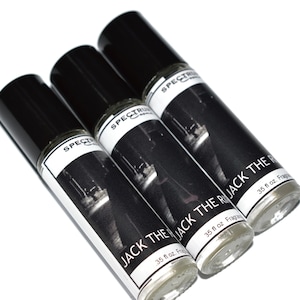 May include: Three black roll-on bottles with white labels. The labels have a black and white photo of a person and the text "JACK THE RI JACK THE RI JACK THE RI" with "35 fl oz. Frag" below.