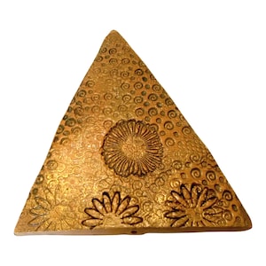 May include: A set of three ceramic mugs with a speckled, matte finish in cream, light brown, and dark brown. Each mug has a simple design and a rounded handle.