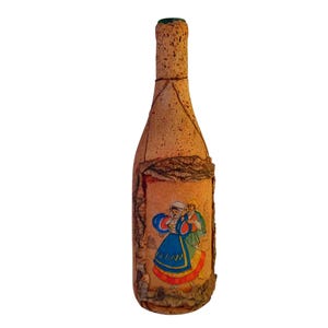 Op de afbeelding: Een decoratieve wijnfles met een kurken buitenkant en een groene bovenkant. De fles heeft een etiket met een kleurrijke illustratie van twee mensen in traditionele kleding. De fles is ontworpen om wijn te bevatten.
