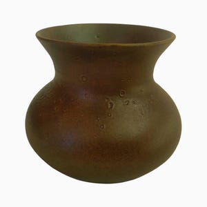 May include: A brown ceramic vase with a bulbous body and a flared rim. The vase has a textured surface with small, irregular bumps. The color is a warm, earthy brown, suitable for home decor.