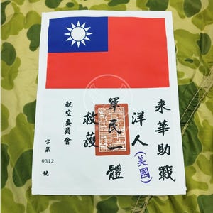 Può includere: Una toppa bianca con la bandiera di Taiwan, un sigillo rosso con caratteri cinesi e testo nero in caratteri cinesi che recita "未華助戰 洋人(美國) 華氏一體 救護 字第 0312 號".