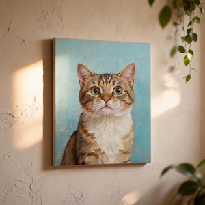 May include: A canvas print featuring a detailed portrait of a tabby cat. The cat has brown and tan stripes, with a white chest and a focused gaze. The background is a soft, light blue, creating a serene and artistic feel.