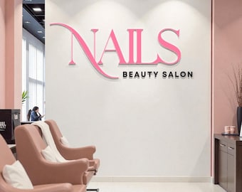 May include: Interior shot of a nail salon with a white wall featuring the pink text "NAILS BEAUTY SALON." The salon has pink armchairs and a dark wood cabinet. The floor is white tile.