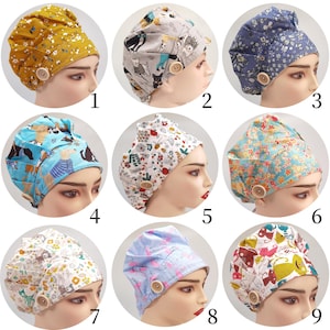 May include: Nine different patterned scrub caps, each featuring a unique design. The caps include floral, animal, and abstract patterns in various colors. Each cap has a wooden button detail.