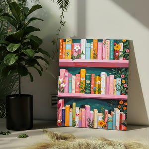 May include: A colorful bookshelf art print featuring rows of books with floral and botanical designs. The books are arranged on pink shelves against a dark green background. The artwork includes daisies, sunflowers, and other flowers.