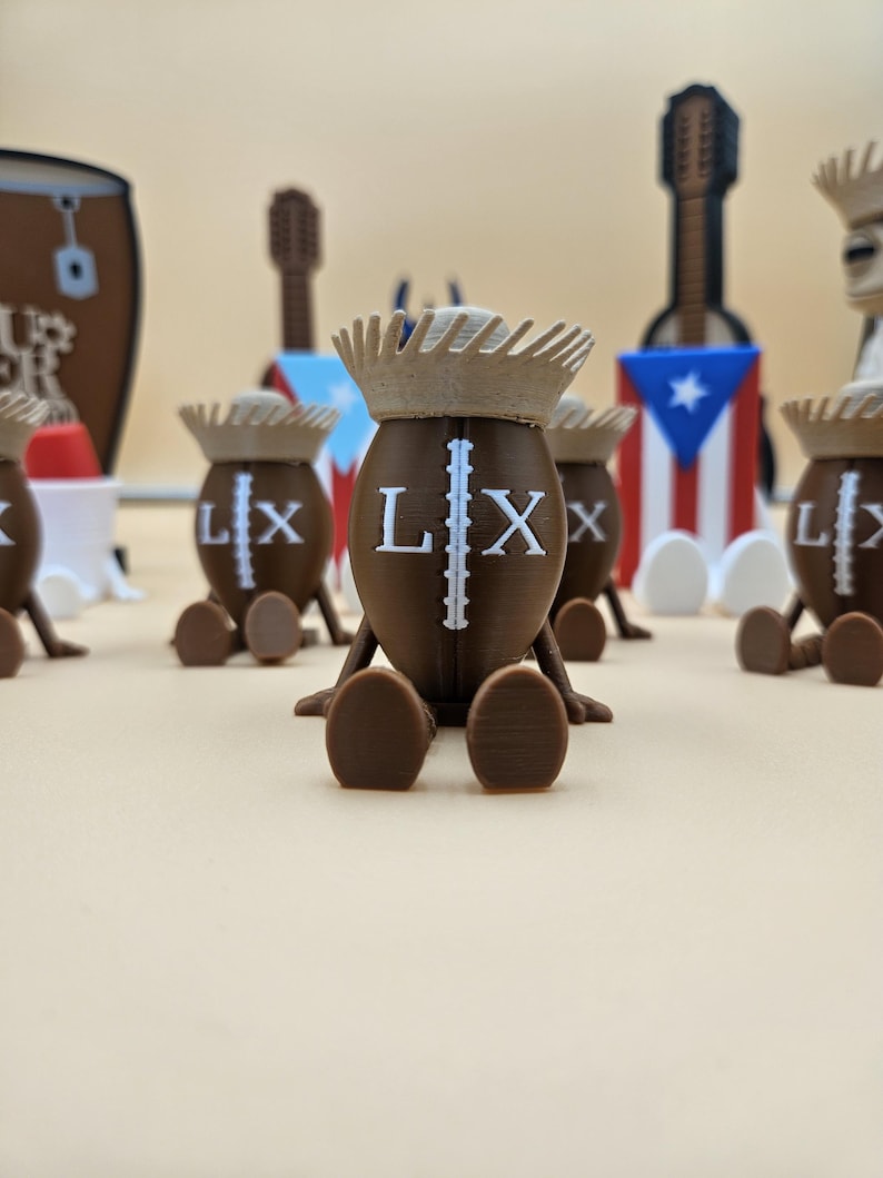 May include: A collection of brown, football-shaped figurines with the letters "LX" and a vertical line printed on them. Each figurine has a light brown crown and is sitting down. In the background are miniature guitars and a Puerto Rican flag.
