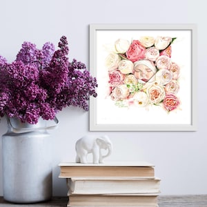 Puede incluir: Una pintura de acuarela de un bebé recién nacido durmiendo en una cama de rosas blancas y rosas. La pintura está enmarcada en un marco blanco y tiene el texto "El amor está eternamente en flor" escrito debajo de la imagen.
