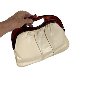 1970s clutch bag with caramel lucite handle and lifting clasp