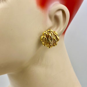 May include: Gold tone clip-on earrings with a twisted rope design.