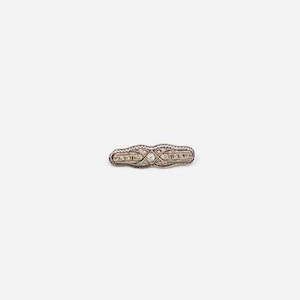 May include: A silver brooch with a diamond-shaped design and small clear stones.