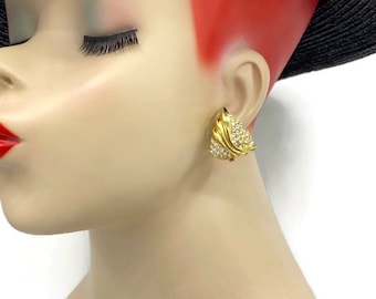 May include: Gold tone earrings with clear rhinestones in a leaf design.