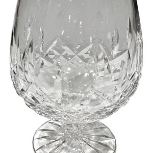 May include: A clear glass brandy snifter with a cut crystal design. The snifter has a round bowl and a wide, flat base.