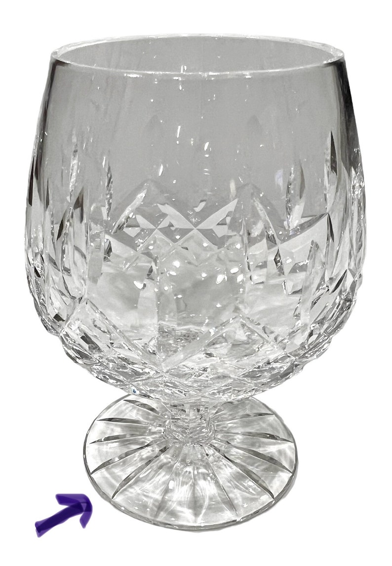 May include: A clear glass brandy snifter with a cut crystal design. The snifter has a round bowl and a wide, flat base.